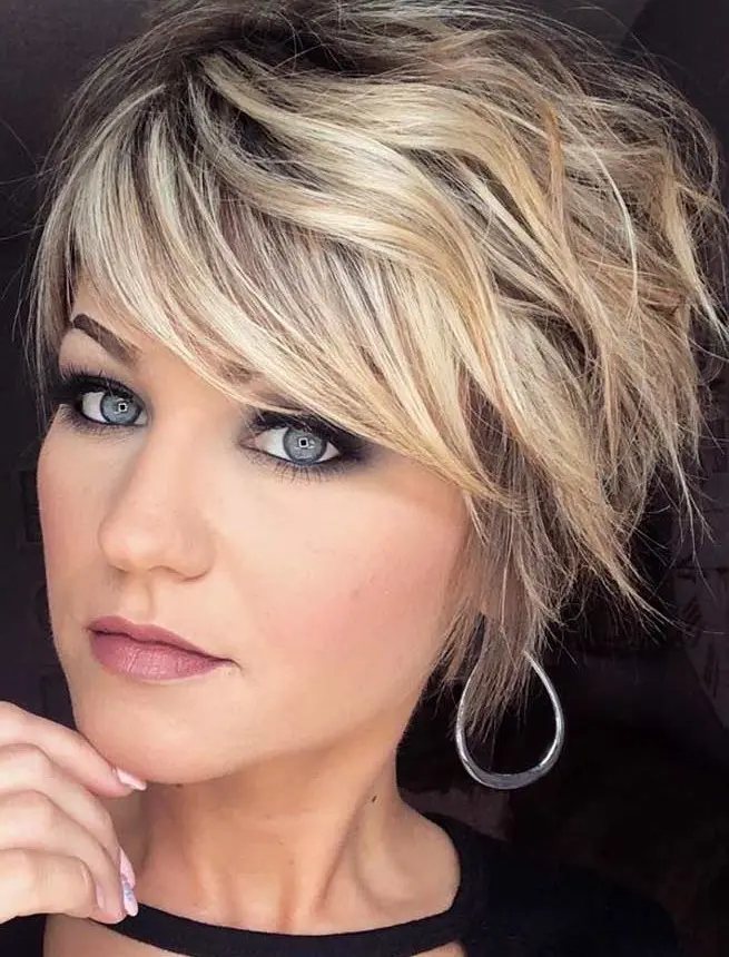 a cool blonde layered and shaggy pixie haircut with a darker root is a very stylish idea that pops up