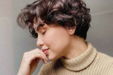 a dark brown wavy and curly pixie with a bit of short bangs is a lovely and cute idea to rock