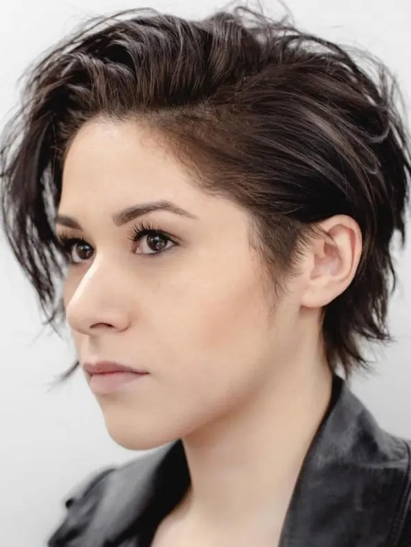 a messy pixie haircut with layers and a long fringe play well with the messy look and give an almost carefree attitude