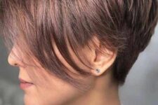 a shiny mauve pixie haircut with a long fringe is a cool and chic idea to rock, it looks bold yet its soft shade makes it more subtle
