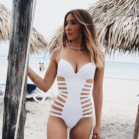 a white one piece strappy side swimsuit with spaghetti straps for a super sexy look