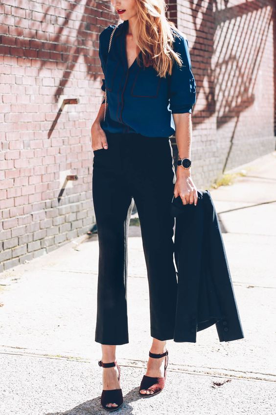a black suit with cropped flare pants, a blue shirt, brown shoes for a unique work look
