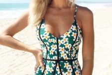 06 a green floral one piece swimsuit with black stripes to highlight the silhouette
