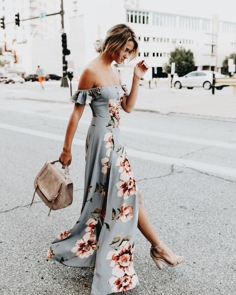 a light grey off the shoulder dress with a large floral print and a side slit