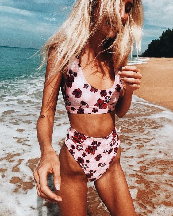 a floral print two piece swimsuit with a high waisted bottom and a simple scoop neckline