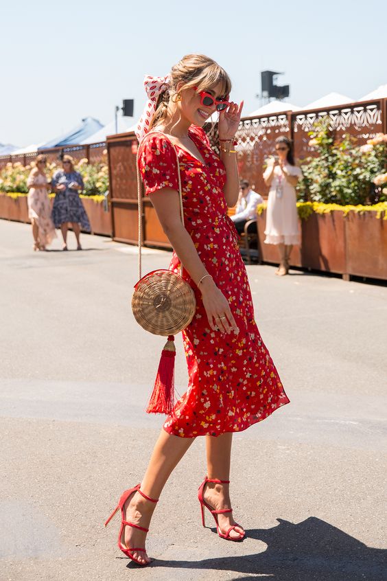 a hot red floral print midi dress with short sleeves and a V-neckline, striped shoes and a round straw bag