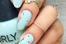 16 mint nails – some with pink flamingos and some with white patterns on them