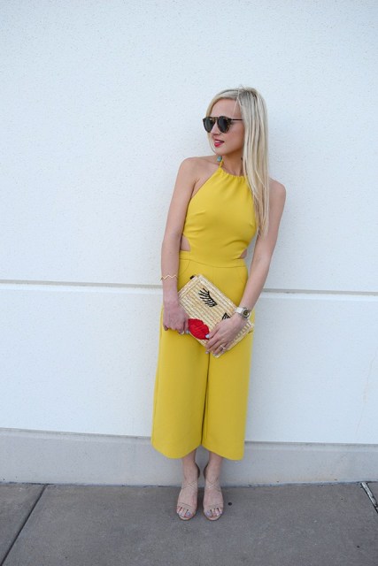With beige sandals, sunglasses and printed clutch