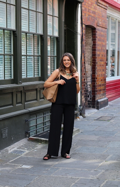 With black jumpsuit and black sandals