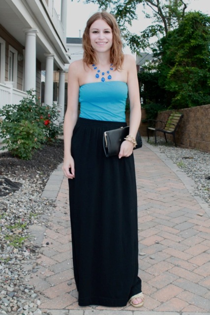 With black maxi skirt and black clutch