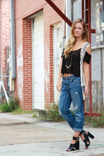 With black off the shoulder top, cuffed distressed jeans and black leather sandals