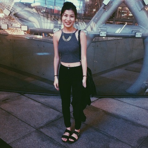 With black pants, flat sandals and bag