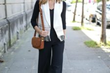 With black shirt, brown small bag, black culottes and black ankle strap shoes