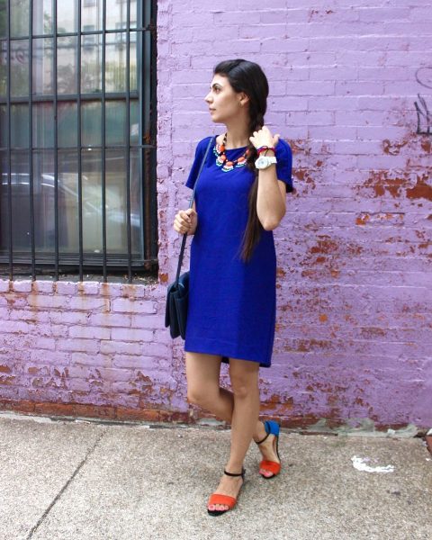 With blue dress, necklace and bag