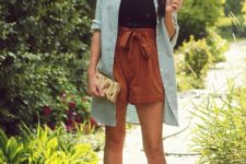 With button down long shirt, high-waisted shorts, clutch and pumps