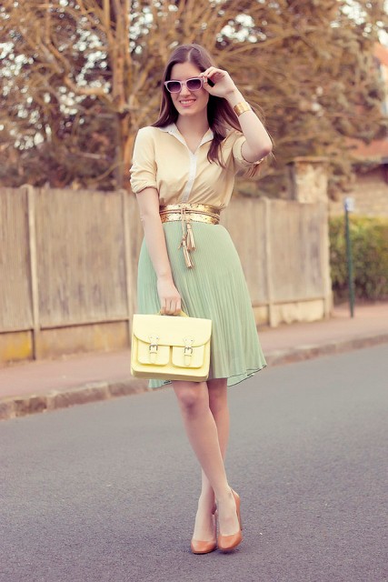 With button down shirt, mint green pleated skirt, yellow bag and orange shoes