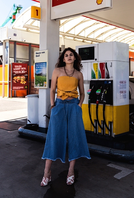 With denim culottes and printed sandals