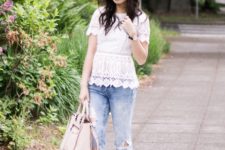 With distressed jeans, beige shoes and beige bag