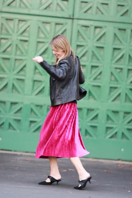 With hot pink midi skirt and leather jacket