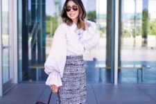 With knee-length skirt, black high heels and black tote