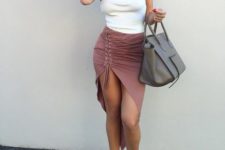 With lace up skirt, gray bag and high heels