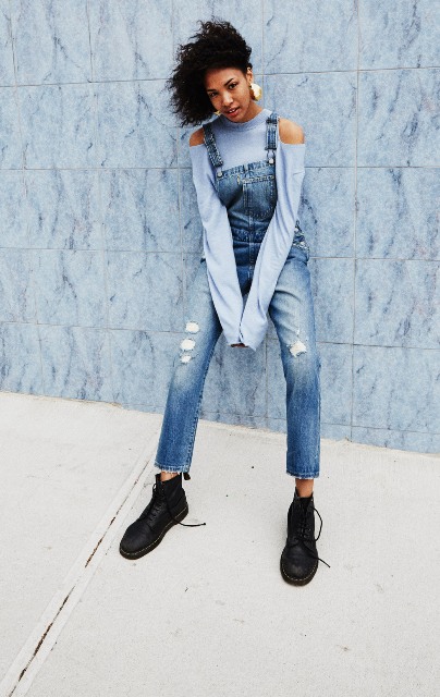 With light blue off the shoulder shirt and lace up flat boots