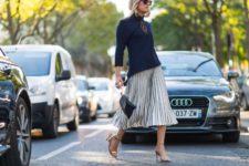 With navy blue shirt, pleated skirt and black bag