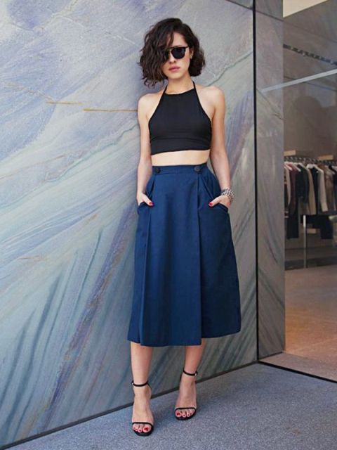 With navy blue skirt and high heels