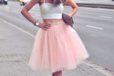 With pale pink skirt, clutch and pink pumps