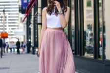 With pink pleated midi skirt, white sandals and white chain strap bag