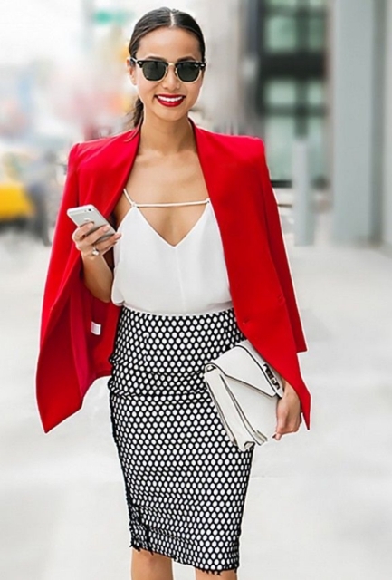 With printed skirt, red blazer and white clutch
