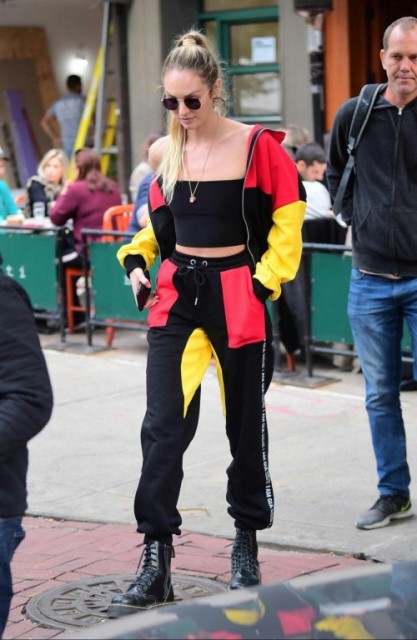 With red, yellow and black bomber jacket, joggers and lace up boots