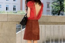 With suede skirt, black bag and orange pumps