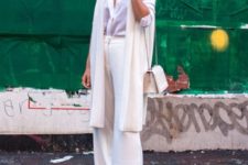 With white button down shirt, white long cardigan, pumps and small bag