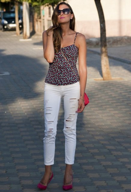 With white distressed pants, red bag and red shoes