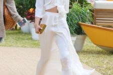 With white maxi skirt, golden sandals and golden mini clutch