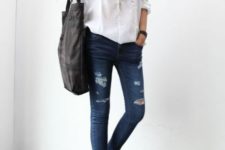 With white shirt, black tote and distressed jeans