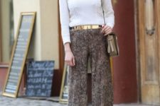 With white shirt, wide leg pants and beige bag