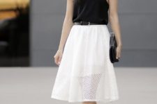 With white skirt, silver sandals and clutch