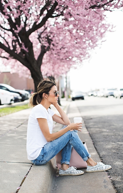 With white t shirt, pale pink bag and cuffed jeans