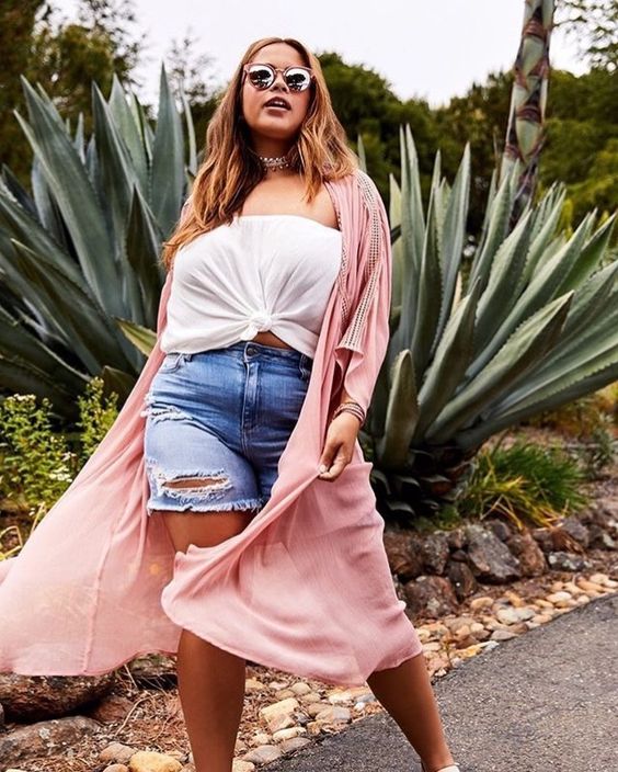 a white strapless crop top, blue denim, a pink kimono for a boho-inspired look