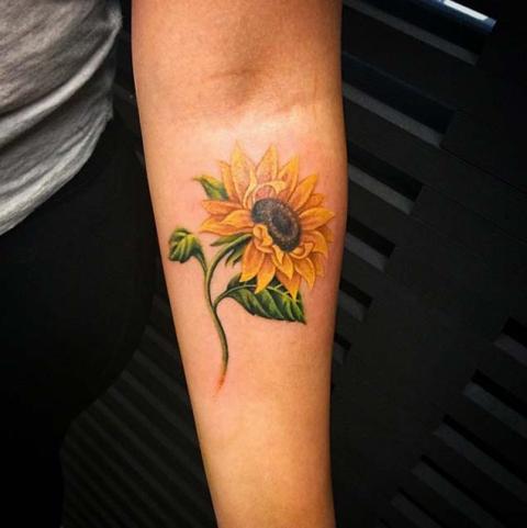 Awesome sunflower tattoo on the hand