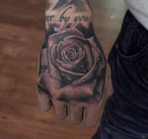 Big rose tattoo on the hand