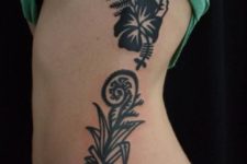Black fern and flowers tattoo on the side