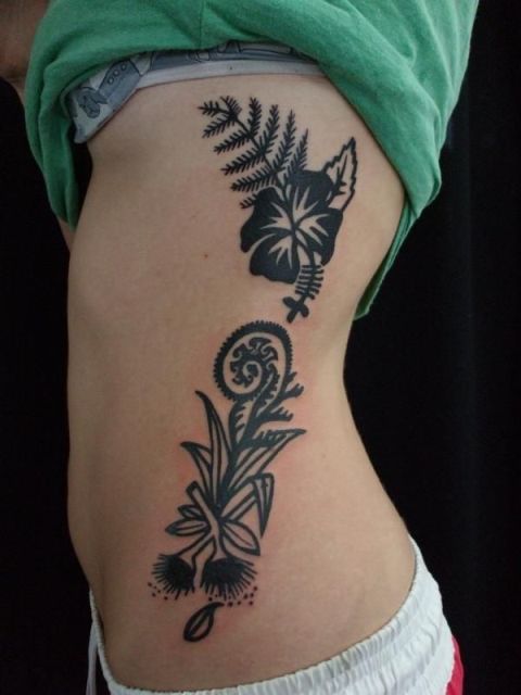 Black fern and flowers tattoo on the side