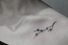 Black small tattoo on the shoulder
