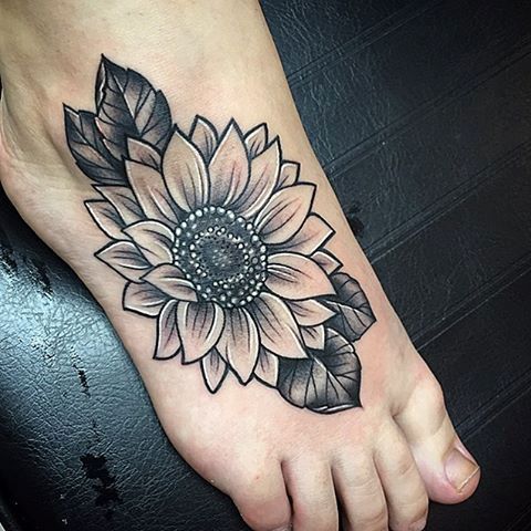 Black sunflower tattoo on the foot