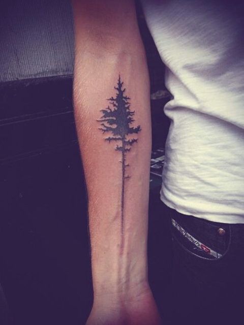 Black tree tattoo on the arm