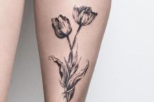 Black tulip tattoo on the leg