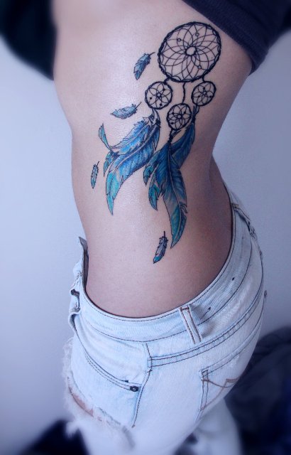 Blue dreamcatcher tattoo on the side